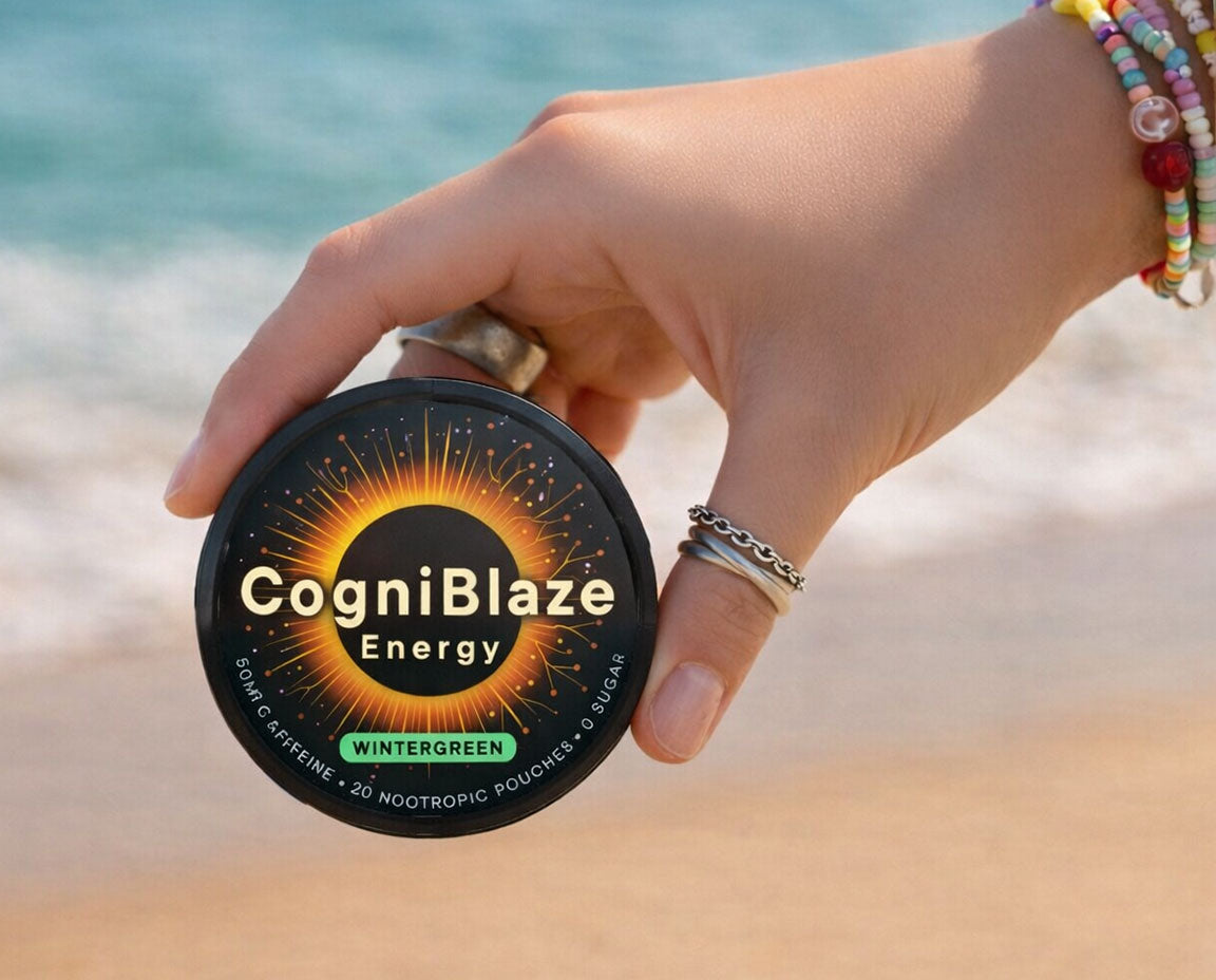 Hand holding a container of CogniBlaze Energy Pouches on a beach